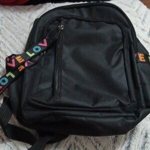 Backpack with the word love writen on the sides and zippers